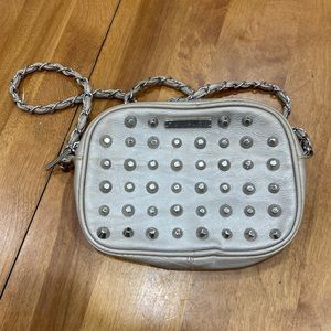 Studded cross-over handbag.